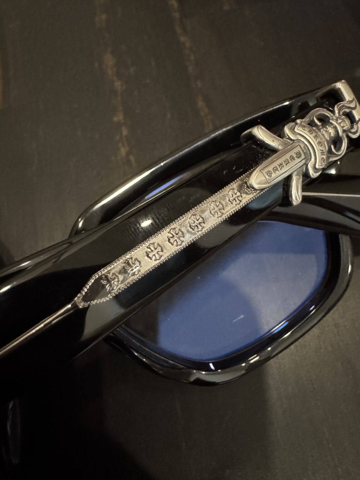 Comparison of authentic versus fake Chrome Hearts sunglasses focusing on engraving, hinges, and materials